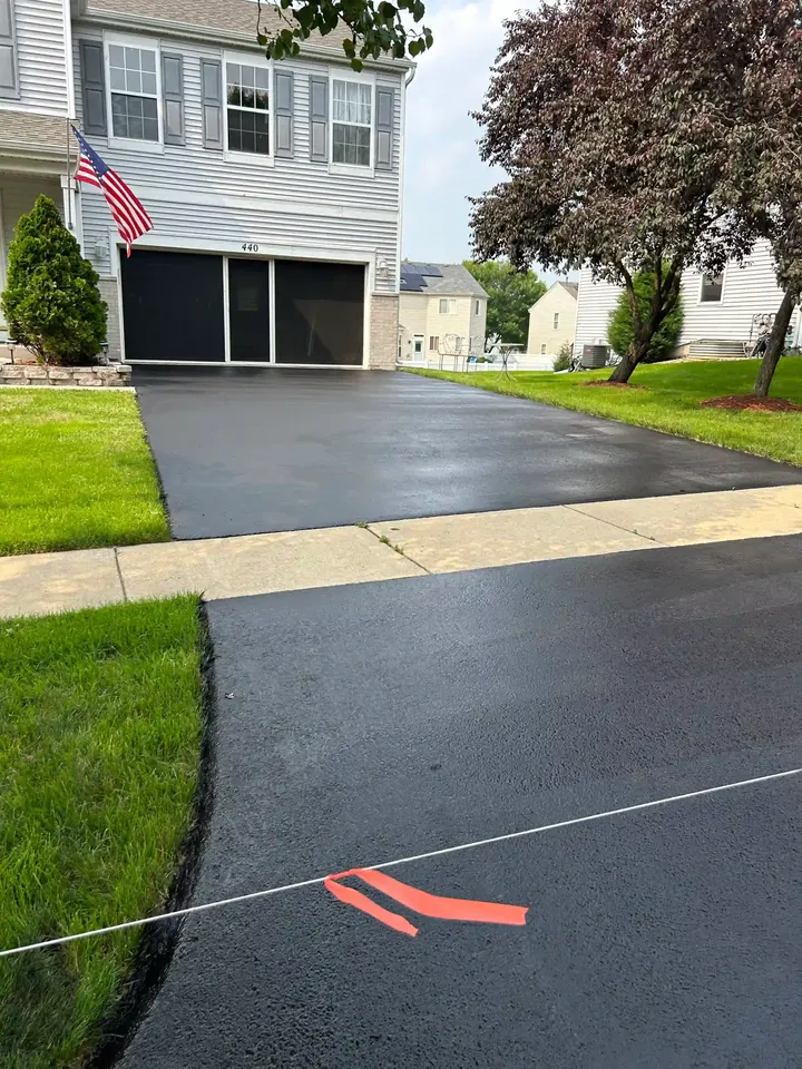 Blocked-off driveway entrance outside a white house
