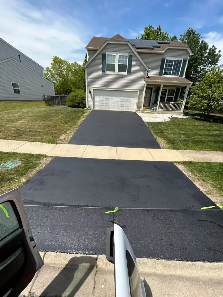 Long residential driveway with safety tape across the entrance