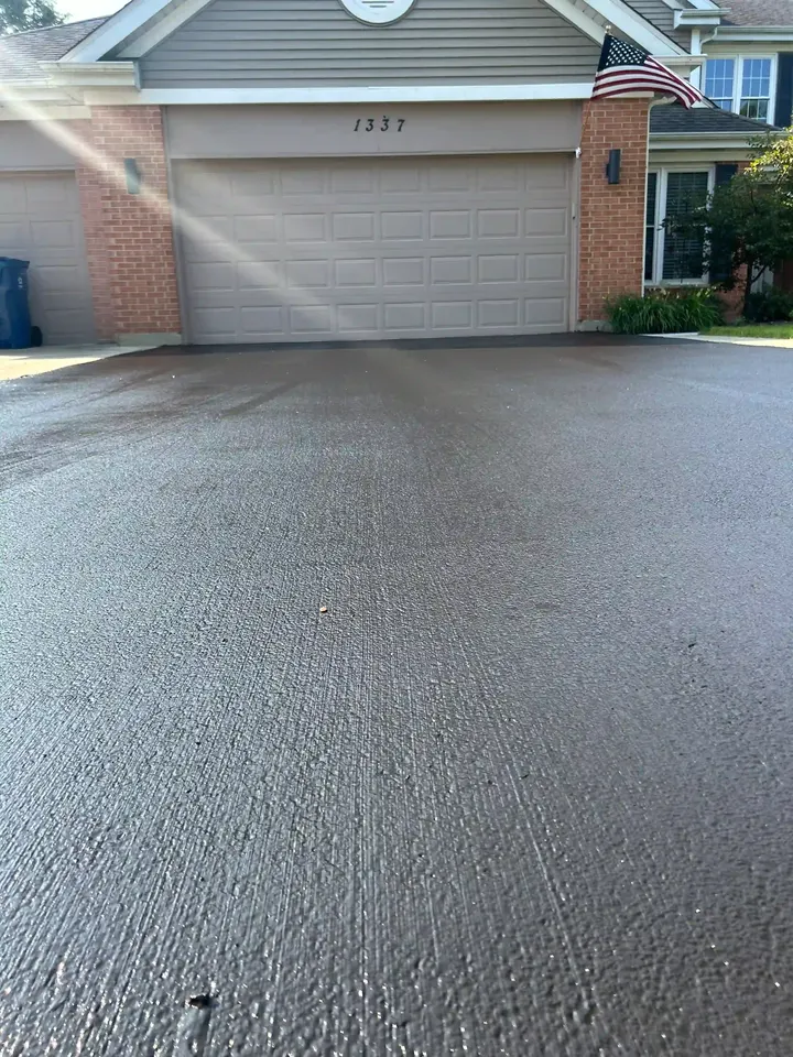 Close-up of driveway texture in front of a two-car garage